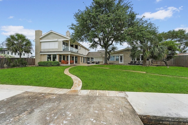 18 S Shore Dr S, Galveston, TX 77551 - exterior space with a chimney, fence, covered porch, and a front yard