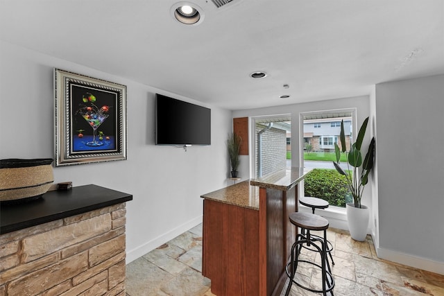 18 S Shore Dr S, Galveston, TX 77551 - bar with recessed lighting, baseboards, and stone tile flooring