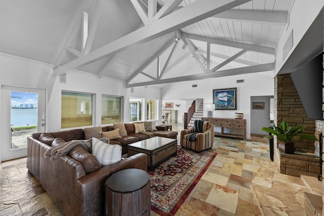 18 S Shore Dr S, Galveston, TX 77551 - living room featuring stone tile floors, a water view, high vaulted ceiling, and beamed ceiling