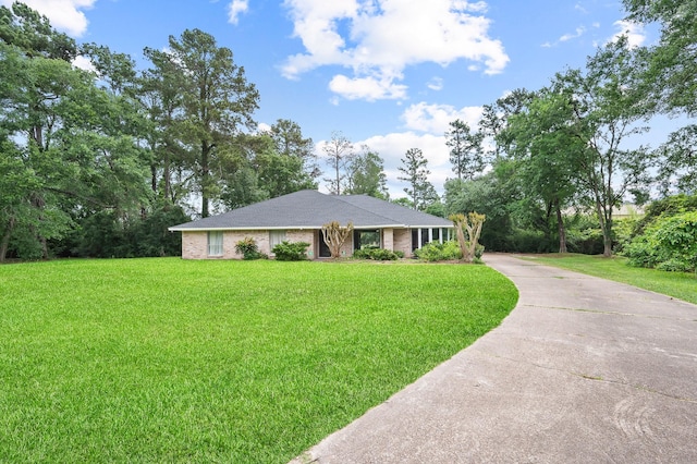 single story home with driveway and a front yard