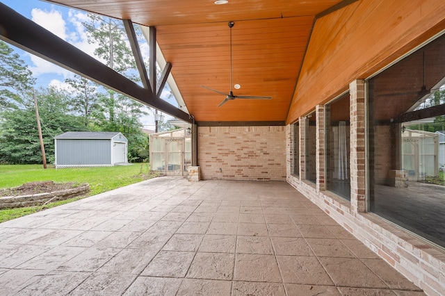 view of patio / terrace with a ceiling fan and an outbuilding