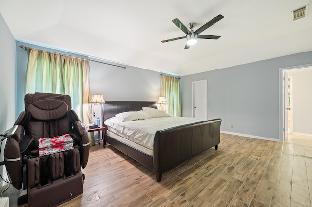 bedroom featuring a ceiling fan, baseboards, visible vents, and wood finished floors