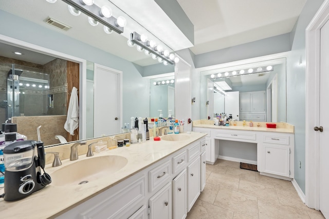 bathroom with visible vents, a sink, a stall shower, and double vanity