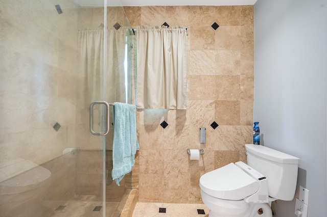 bathroom with toilet and a shower stall