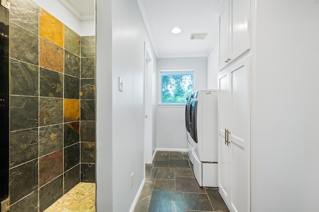 laundry room with laundry area, stone tile floors, visible vents, ornamental molding, and baseboards