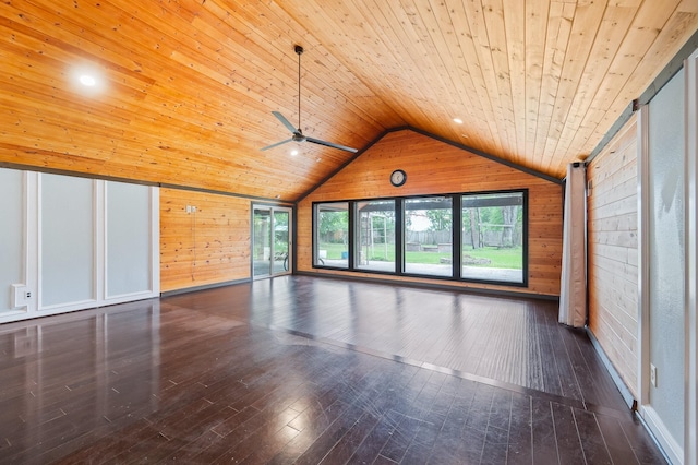 interior space featuring wooden walls, wooden ceiling, vaulted ceiling, and a wealth of natural light