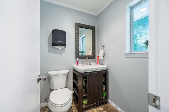 half bathroom featuring baseboards, plenty of natural light, crown molding, and toilet