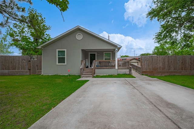bungalow with a porch, fence, and a front yard