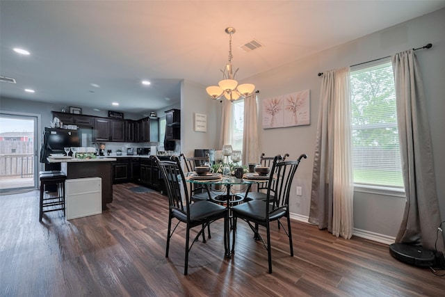 dining space with a notable chandelier, visible vents, dark wood-style floors, and a healthy amount of sunlight