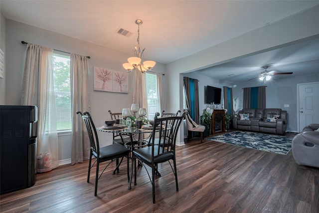 dining room with a healthy amount of sunlight, baseboards, dark wood finished floors, and visible vents
