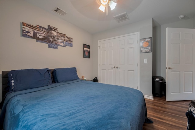 bedroom featuring visible vents, dark wood-type flooring, a closet, and ceiling fan