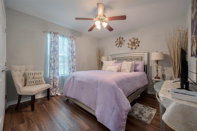 bedroom with baseboards, a ceiling fan, and dark wood finished floors