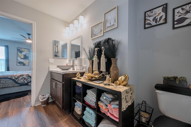 ensuite bathroom with vanity, wood finished floors, toilet, ensuite bathroom, and a ceiling fan