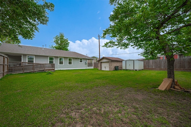 view of yard featuring a storage unit, a fenced backyard, and an outdoor structure