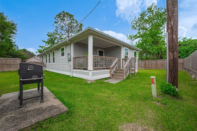 view of front of property with a fenced backyard and a front lawn