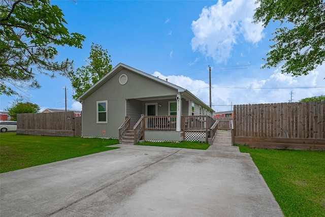 bungalow featuring a porch, fence, and a front yard