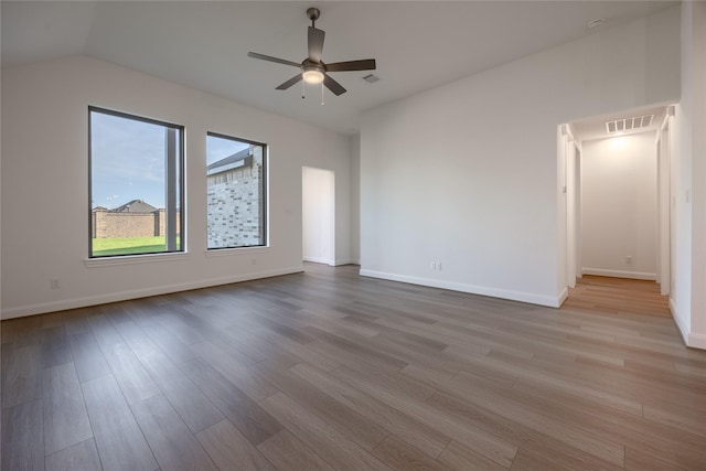 12810 Belford Gardens Dr, Humble, TX 77346 - unfurnished room with wood finished floors, baseboards, a ceiling fan, and vaulted ceiling