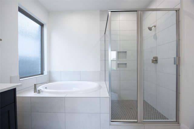 12810 Belford Gardens Dr, Humble, TX 77346 - bathroom featuring a bath, a shower stall, and vanity
