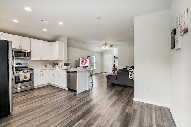 kitchen featuring a peninsula, open floor plan, appliances with stainless steel finishes, and visible vents