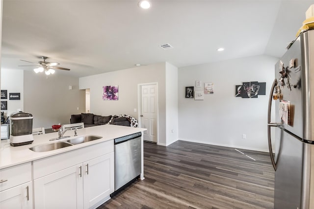 kitchen with visible vents, open floor plan, white cabinetry, a sink, and stainless steel appliances
