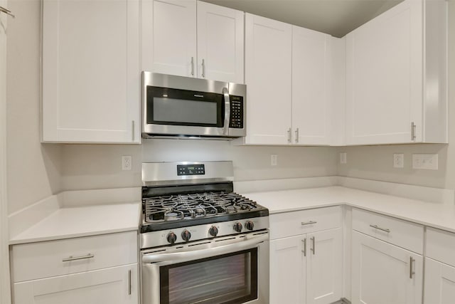 254 Cumberland Forest Dr, Magnolia, TX 77354 - kitchen featuring stainless steel appliances, white cabinets, and light countertops