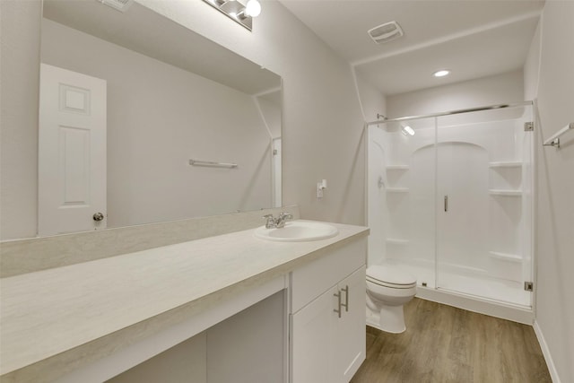 254 Cumberland Forest Dr, Magnolia, TX 77354 - bathroom featuring toilet, wood finished floors, a stall shower, vanity, and recessed lighting