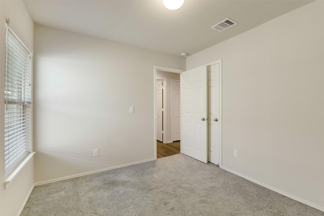 254 Cumberland Forest Dr, Magnolia, TX 77354 - unfurnished bedroom featuring carpet, multiple windows, and baseboards