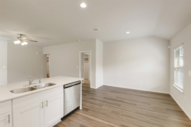 254 Cumberland Forest Dr, Magnolia, TX 77354 - kitchen with stainless steel dishwasher, a sink, white cabinets, light wood finished floors, and light countertops
