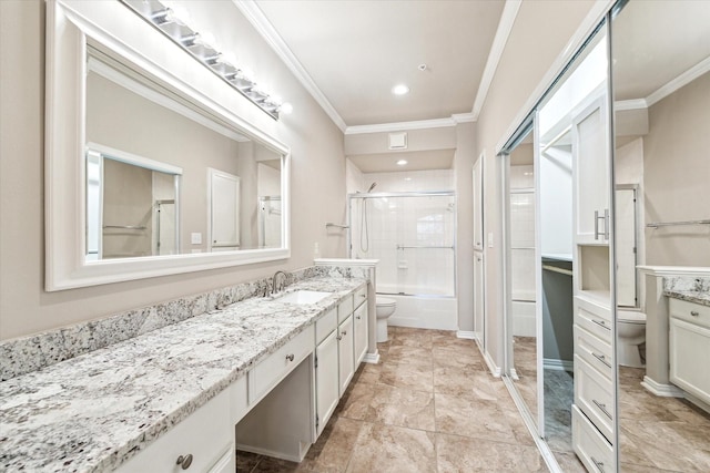 full bathroom with crown molding, combined bath / shower with glass door, toilet, and vanity