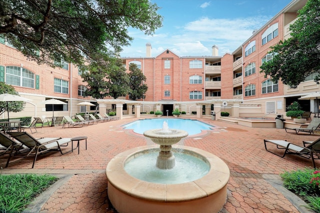 community pool featuring a patio area
