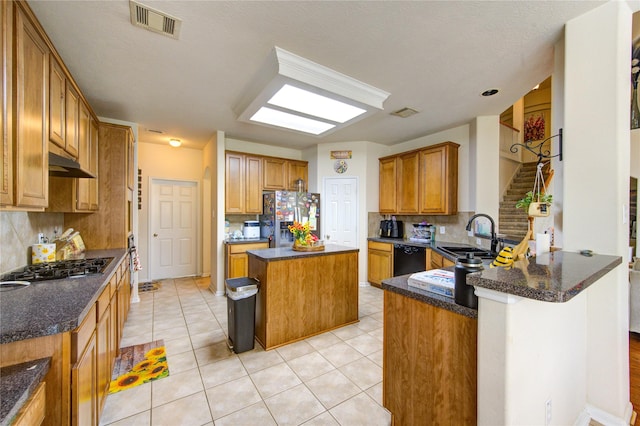 kitchen with stainless steel fridge with ice dispenser, backsplash, under cabinet range hood, and dishwasher