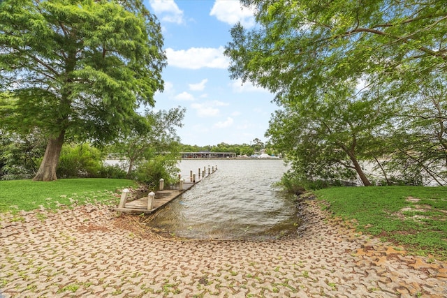 exterior space with a lawn and a water view