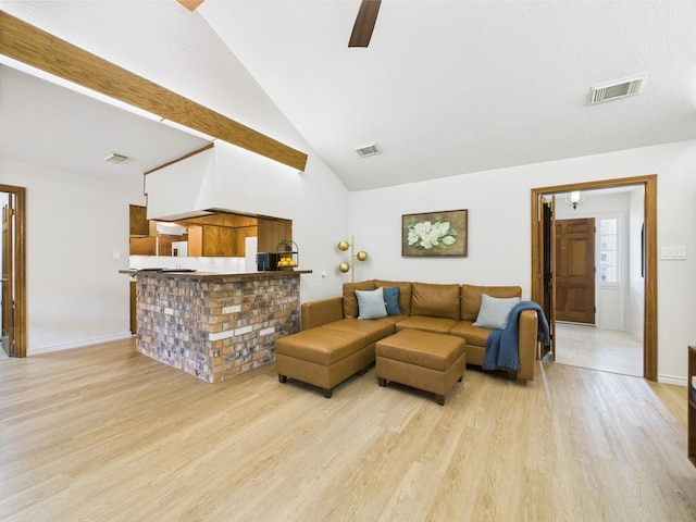 living room with visible vents, a ceiling fan, and light wood-style flooring