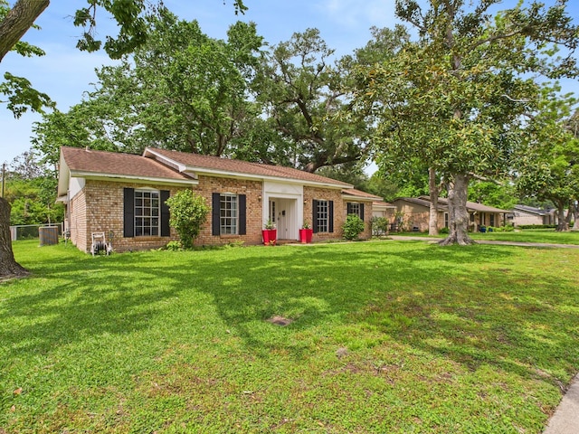 single story home with brick siding, central AC, and a front yard