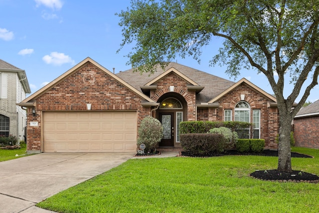 ranch-style house with an attached garage, concrete driveway, a front yard, and brick siding
