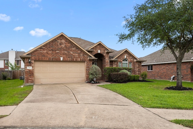 ranch-style home with brick siding, a garage, a front lawn, and concrete driveway