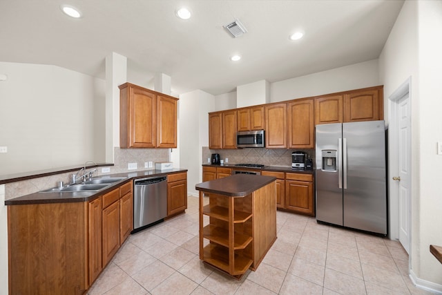 kitchen featuring dark countertops, open shelves, a sink, stainless steel appliances, and visible vents