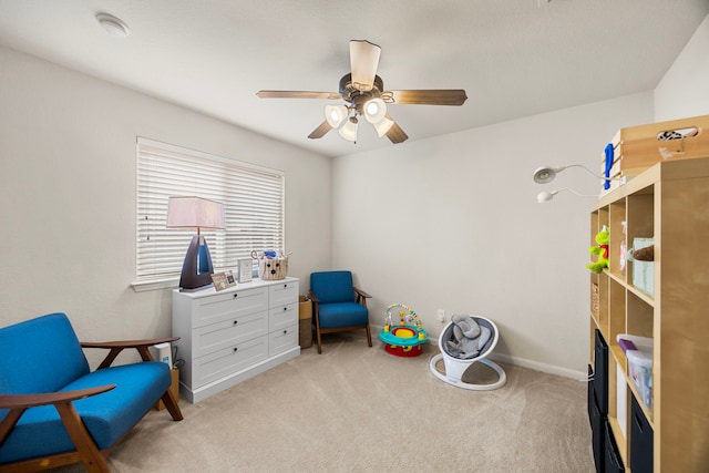 playroom featuring ceiling fan, light colored carpet, and baseboards