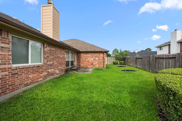 view of yard featuring a patio and a fenced backyard