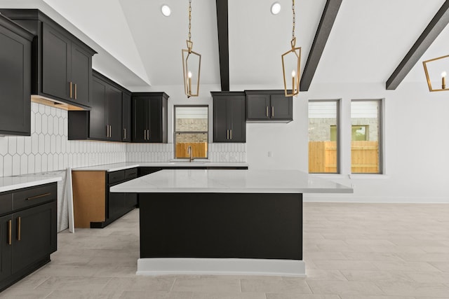 kitchen with backsplash, lofted ceiling with beams, a wealth of natural light, and a center island