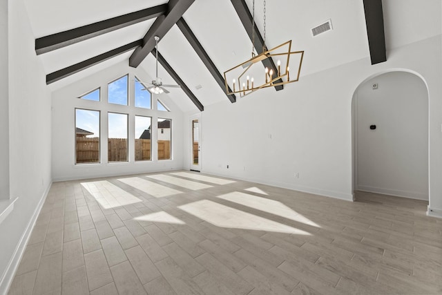 unfurnished living room featuring visible vents, beam ceiling, light wood-style floors, arched walkways, and ceiling fan with notable chandelier