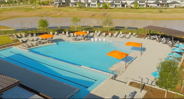 pool featuring a residential view and a patio area
