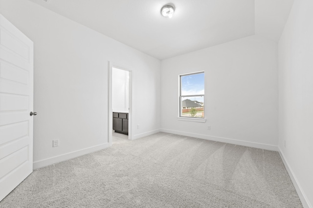 unfurnished room with baseboards and light carpet