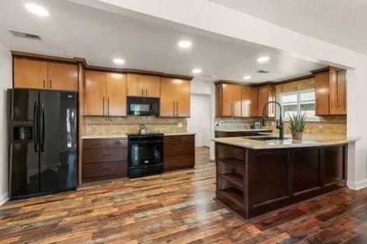 79 Summers Wind St, Montgomery, TX 77356 - kitchen with black appliances, a sink, light countertops, dark wood-type flooring, and backsplash