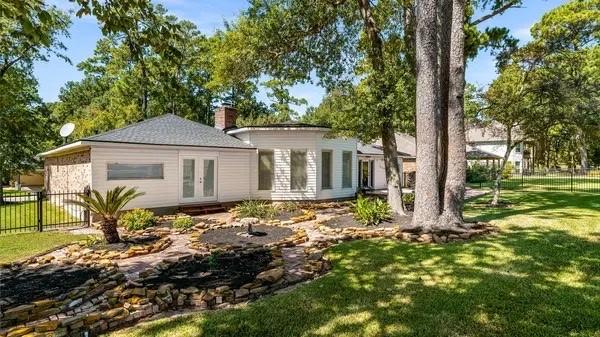 back of property with a yard, fence, french doors, and a chimney