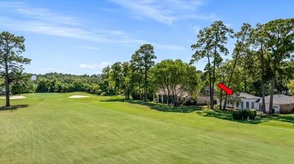 view of property's community featuring a yard and golf course view