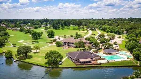 birds eye view of property with a water view and golf course view