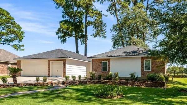 79 Summers Wind St, Montgomery, TX 77356 - ranch-style house featuring a garage, brick siding, concrete driveway, and a front lawn