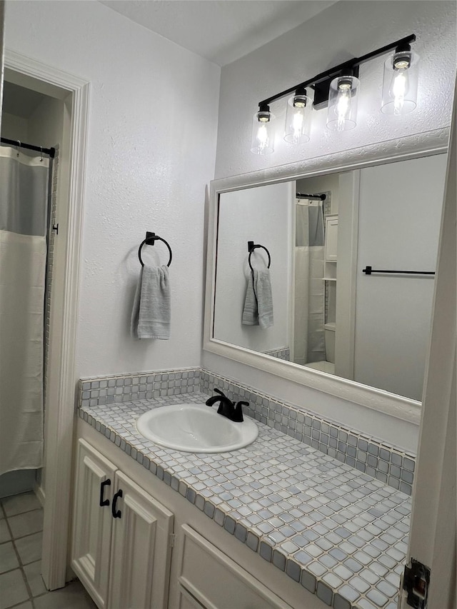 full bathroom featuring vanity and tile patterned flooring
