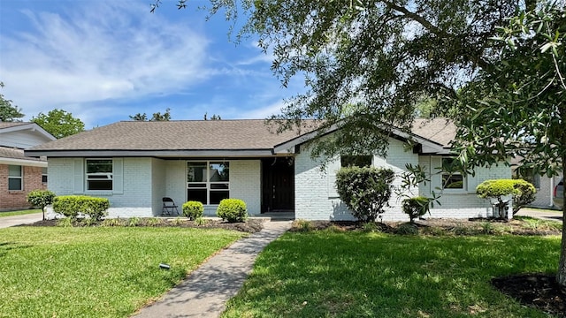 5514 Cheena Dr, Houston, TX 77096 - view of front of house featuring brick siding, a front lawn, and a shingled roof